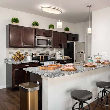 a kitchen with granite counter tops and stainless steel appliances