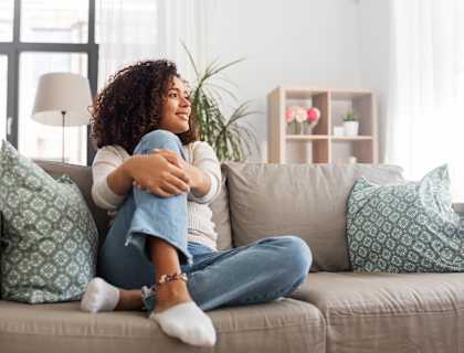 a woman sitting on a couch with her legs crossed