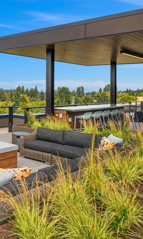 the deck has a jacuzzi and patio furniture with views of the city  at The Hemlock, Seattle, WA