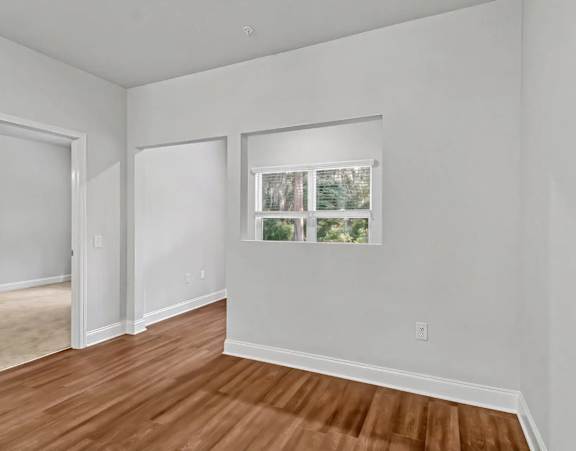 an empty room with carpet and a window at Uphill Flats, Decatur, GA, 30032