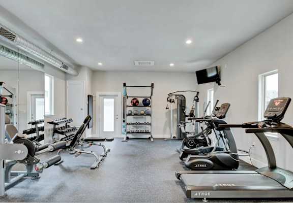 A well-equipped gym with a variety of cardio and strength training equipment.