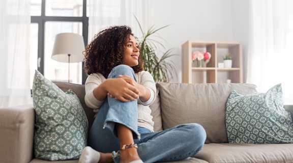 a woman sitting on a couch with her legs crossed