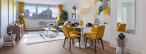 A dining room with a table set for four and a view of the city.