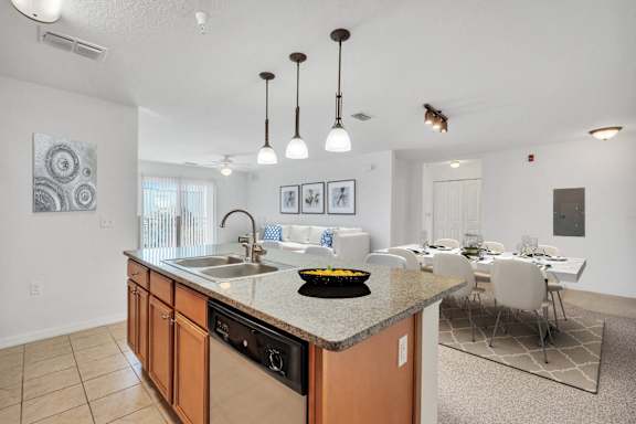 A kitchen with a countertop and a dining table.