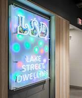 A neon sign that says Lake Street Dwelling.