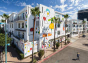 Thumbnail 4 of 9 - a building with a mural on it on the side of a street