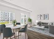 Thumbnail 1 of 7 - A modern living room with a dining table and grey couch.