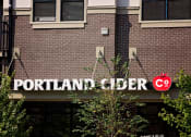 Thumbnail 4 of 14 - a sign for the cider company on a brick building