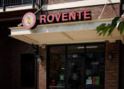 Thumbnail 6 of 14 - a restaurant with a red and white sign on the front of it