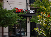 Thumbnail 8 of 14 - a sign for tea and tea on the side of a building