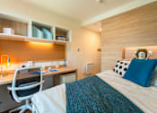 Thumbnail 2 of 8 - a bedroom with a bed and a desk in a room