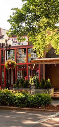 the outside of a restaurant on a street with trees