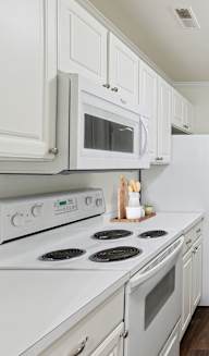 Fully Equipped Kitchen with White Appliances