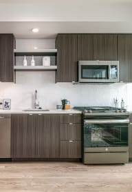 a kitchen with stainless steel appliances and wooden cabinets