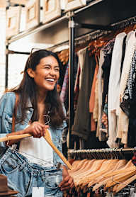 Two women shopping for clothes in a clothing store.