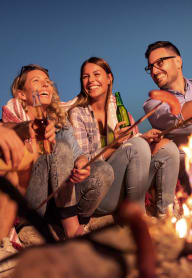 a group of people sitting around a campfire