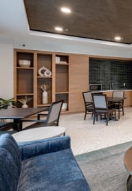 a living room and dining room with a table and chairs