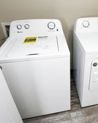 a washer and dryer sit next to each other in a laundry room