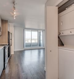 a kitchen and laundry room in a 555 waverly unit