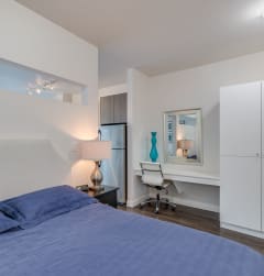 a bedroom with a bed and a desk