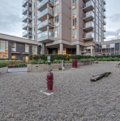 a courtyard with a fire hydrant and benches in front of an apartment building