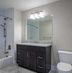 a bathroom with a toilet sink and bathtub at Zephyr Ridge Apartment Homes, Cedar Grove, 07009