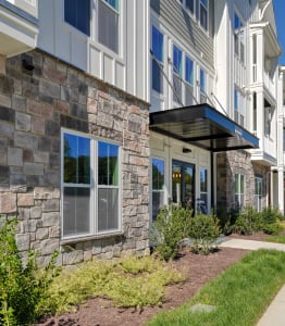 a view of a building with a walkway in front of it at Artistry at Winterfield Apartments, Virginia
