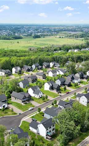 A suburban neighborhood with houses and greenery.