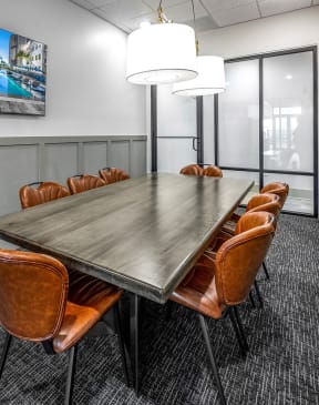 a conference room with a long table and chairs and a tv