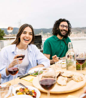 Friends Having Food and Wine Together Smiling