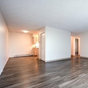 A room with wooden floors and white walls.