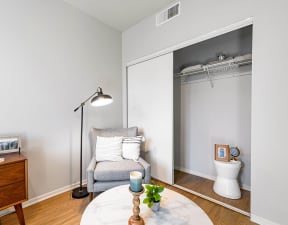 a bedroom with a medium sized bed and a small desk with a chair in front of a