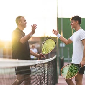 Men Playing Tennis Together Smiling