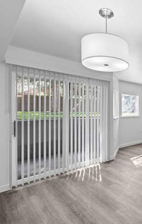A room with a sliding door and a light on the ceiling.