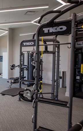 A gym with a variety of equipment including treadmills, weights, and exercise machines at Sterling Nashville West Apartments, Nashville, Tennessee