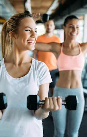 Woman lifting weights at Park Summit Apartments, Georgia