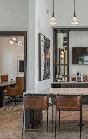 an open kitchen with a granite counter top and stools