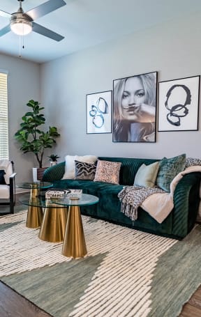 a living room with a green couch and a large window