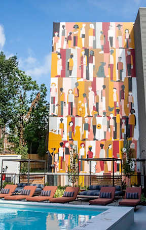 A tall building with a mural of people on it.