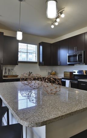 a kitchen with stainless steel appliances and a granite counter top