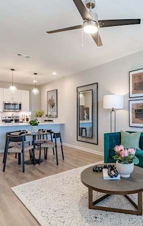 a living room and dining room with a couch and a table