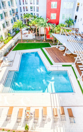 an overhead view of a swimming pool in an apartment building