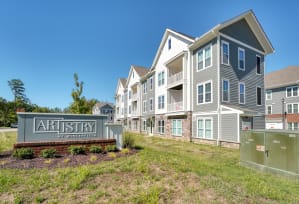 a building with a sign that says artistry of america in front of it at Artistry at Winterfield Apartments, Virginia