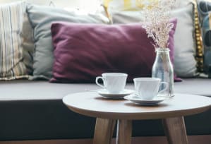 Pillow and Table with Coffee Cups at Hampton Apartments in Clearwater, FL 33759