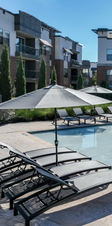 Exterior pool view at Soho Parkway with lounge chairs