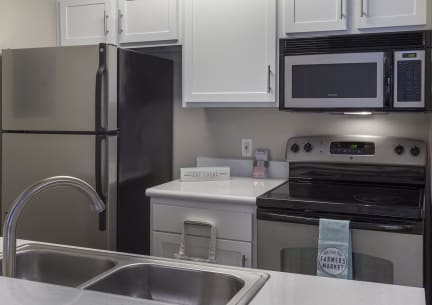 a kitchen with stainless steel appliances and white cabinets