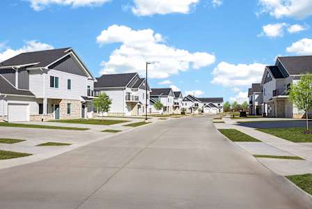 A row of houses with a street in between.