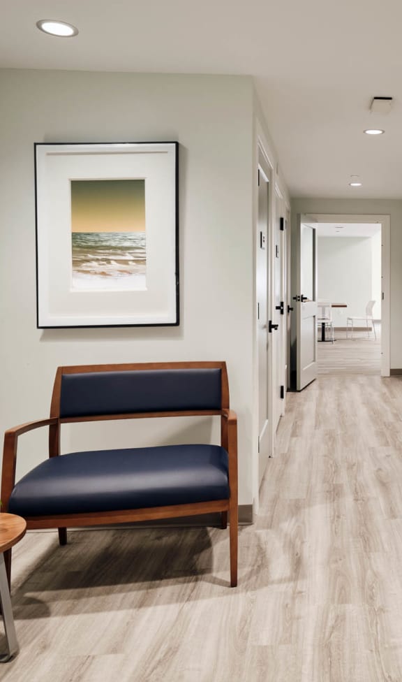 a corridor with a chair and a table