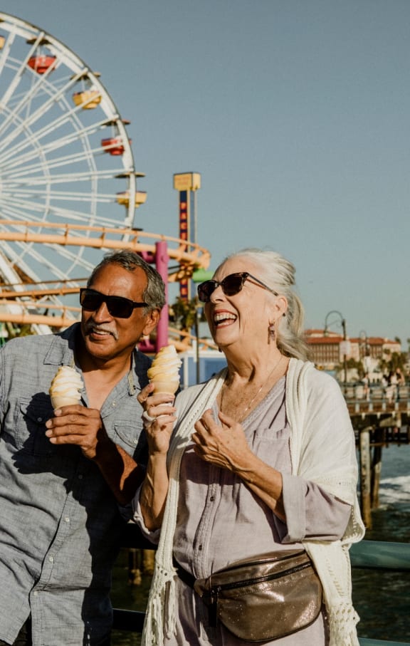 Couple Eating Ice Cream Together on Pier