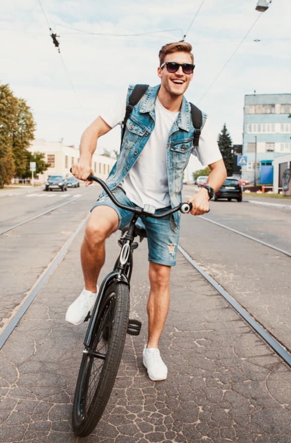 Man Smiling while Riding Bike